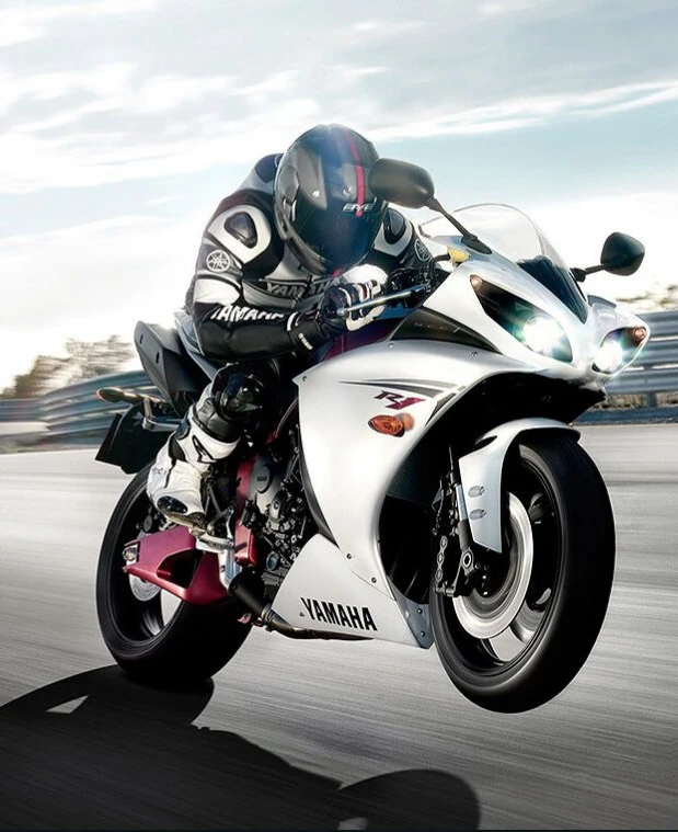 Man on a race track riding a Yamaha R1